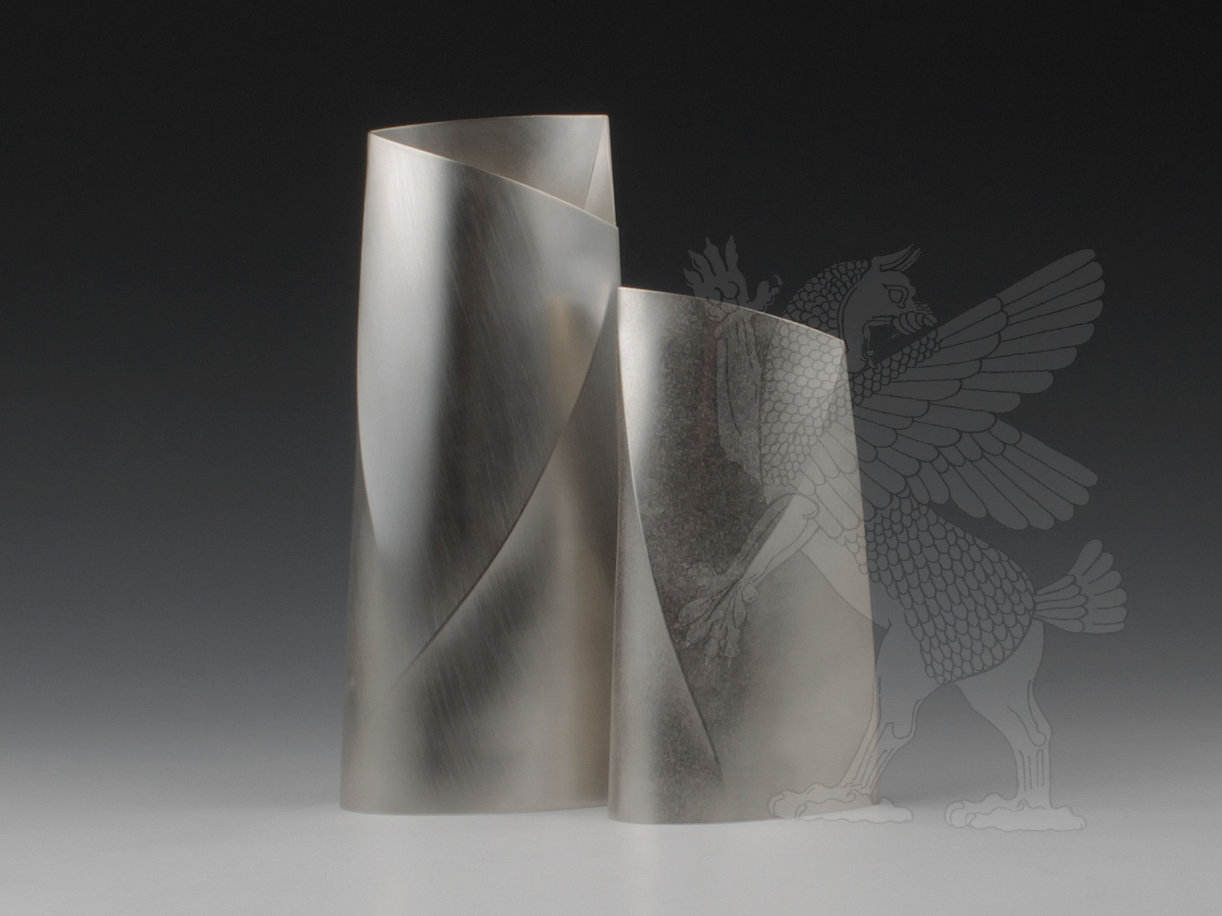 A pair of contemporary sterling silver vases